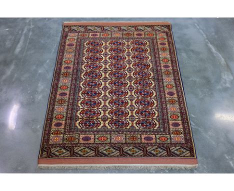 A TURKMEN BOKHARA SILK AND WOOL RUG (167 x 118cm)
Hand knotted silk and wool, cream field with three rows of octagonal guls
O