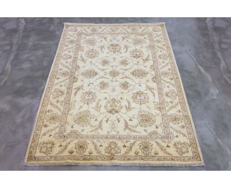 AN AFGHAN WOOL RUG  (238 x 167cm)
Hand knotted wool pile with allover foliate design on a cream field
Ownership Statement: Th