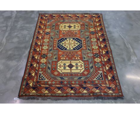 A TURKMEN MIR WOOL RUG (227 x 160cm)
Hand knotted wool pile featuring a geometric design with large central medallions, frame