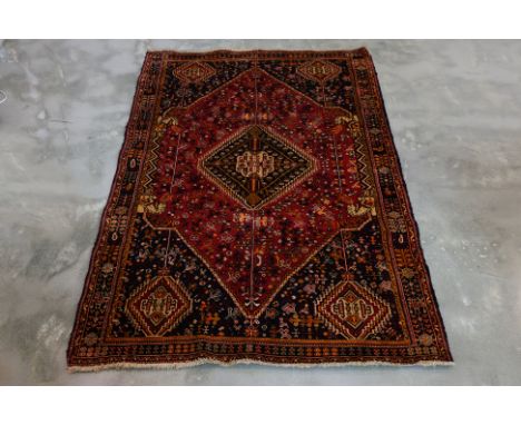 A QASHQAI WOOL RUG (237 x 154cm)
Hand knotted wool with diamond medallions, tribal motifs and geometric borders
Ownership Sta