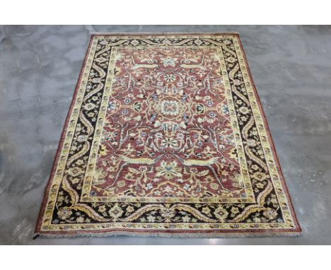 A BIDJAR WOOL RUG (246 x 170cm) Hand knotted wool, a pale red field featuring a central floral medallion and intricate scroll