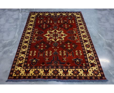 A TURKMEN WOOL RUG (276 x 209cm)
Hand knotted wool, stylised floral design on a burnt sienna field
Ownership Statement: This 
