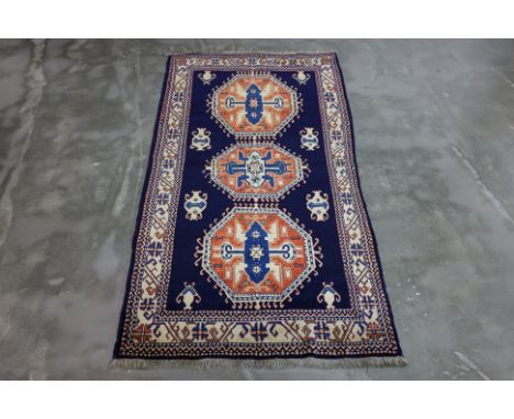 A CAUCASIAN SHIRWAN WOOL RUG (225 x 120cm)
Hand-knotted wool in orange, blue and cream tones, triple medallion design
Ownersh