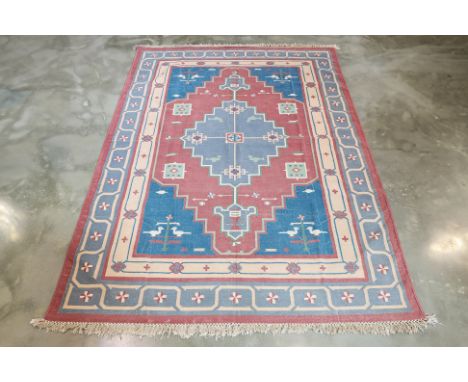 A TURKISH WOOL KILIM (290 x 220cm)
Hand knotted wool pile with geometric medallions, accented by animal motifs and a delicate