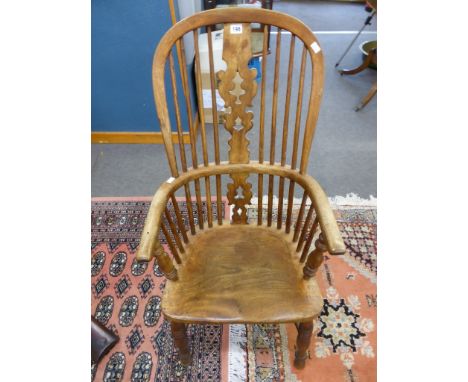 An antique oak stick back Windsor elbow chair.