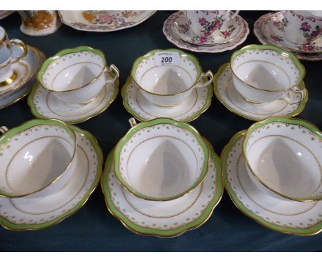 A Collection of Six Green and Gilt Teacups and Saucers by Wylie