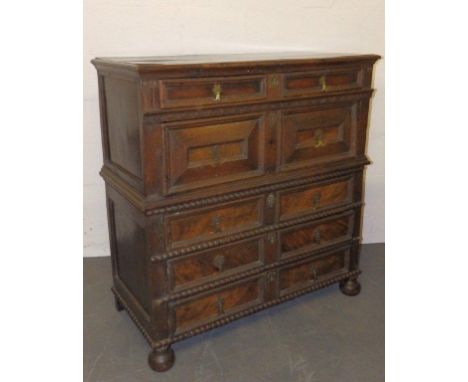 A 17thC oak &amp; walnut two-part chest of drawers, arranged as one shallow, one deep and three shallow drawers, the moulded 