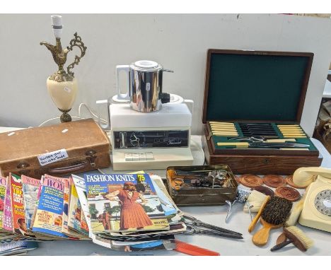 A mixed lot to include a Bakelite telephone, a canteen of cutlery, a collection of 1950's and later women's health/women's ma