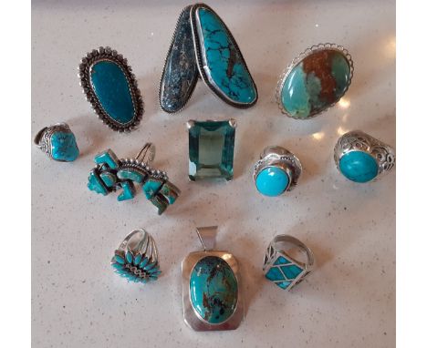 A quantity of 3 silver rings with turquoise coloured cabochons and 9 silver tone/white metal rings having turquoise and green