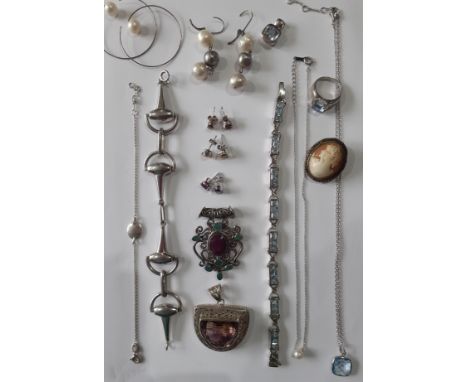 A quantity of silver and silver tone jewellery to include a stirrup style bracelet stamped 800, a silver pendant with smokey/