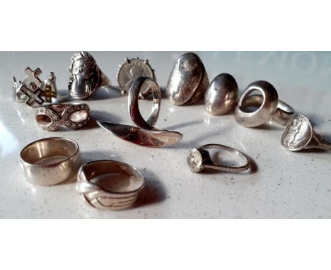 A quantity of 12 silver rings to include a 1958 sixpence ring, one with a neoclassical portrait of a lady and a St Christophe