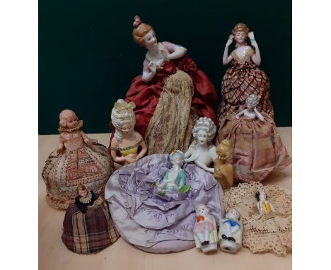 A collection of early to mid 20th Century half doll pin cushions, one stamped CMC, having ceramic, porcelain and other torsos