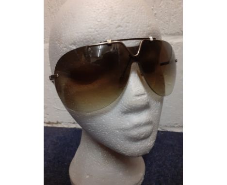 Christian Dior-A pair of late 20th Century gold tone over-sized aviator style frameless sunglasses with brown lenses, no case