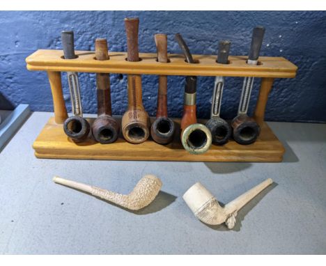 Nine vintage smoking pipes on a standLocation: 