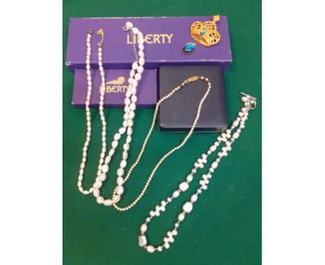 A small group of seed and faux pearl necklaces, a gold tone brooch in the form of a crown A/F, 2 Liberty boxes and one other.