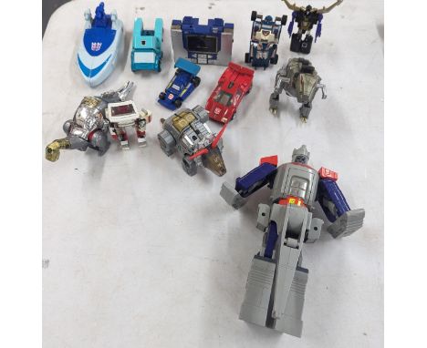 A collection of 1980s Transformers GI figures to include Soundwave A/F, Ratchet cup, a large Galvatron, Dinobets, Sideswipe a