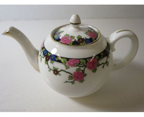 ELDER DEMPSTER: A FLORAL PATTERN PORCELAIN TEAPOT BY AYNSLEY, ENGLAND, CIRCA 1960 
 company name and maker’s mark to base.&nb