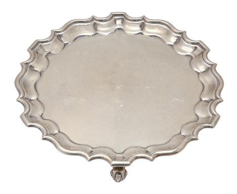 A George V silver salver, on three volute feet, 23cm diam, by Thomas Bradbury &amp; Sons, London 1910, 13oz 15dwt A few light