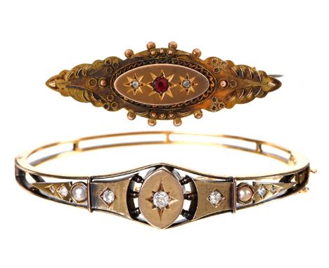 An Edwardian diamond and split pearl bangle, in gold, 56mm (internal), marked 15 and a 9ct gold shuttle shaped brooch, 14g (b