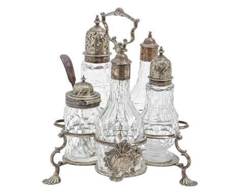 A George III rococo silver cruet frame, the handle centred by a shell, the gallery applied with asymmetrical cast escutcheon 