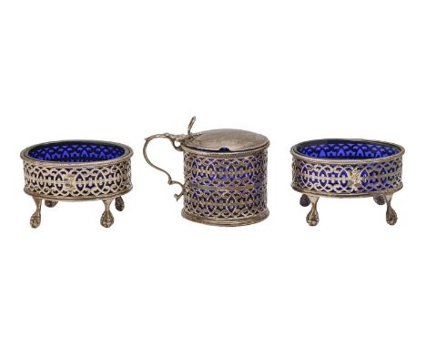 A pair of George III pierced oval silver salt cellars and a mustard pot en suite, crested, blue glass liners, salt cellars 82