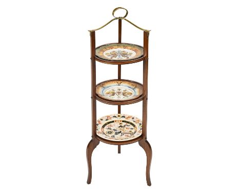 An Edwardian mahogany and brass cake stand, 91cm h, a pair of outside-decorated Rosenthal plates and an English earthenware J