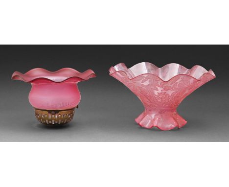 Two cranberry flashed glass lamp shades, early 20th c, one with brass fitment, the other moulded with flowers, 13.5cm h and s