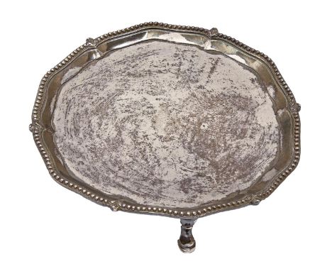 A George III silver waiter, the moulded border with gadrooned rim, on three hoof feet, engraved with contemporary armorials, 