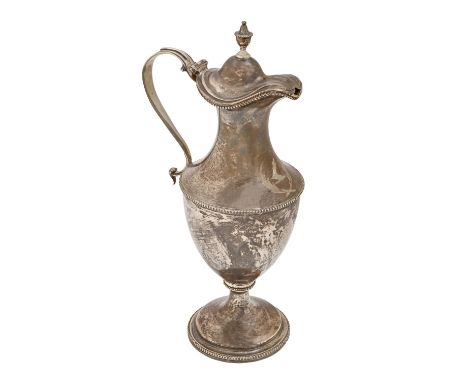 A George III silver lidded jug, of shield shape, the domed lid with vase finial and beaded rims, 35cm h, by Charles Wright, L