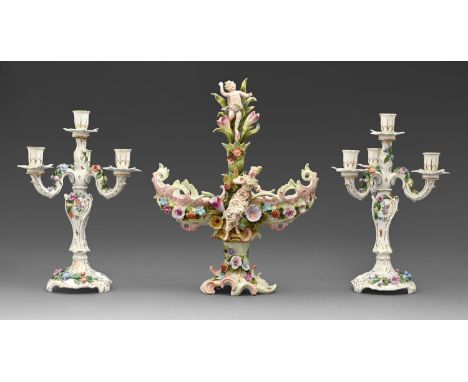 A pair of Carl Thieme porcelain candelabra, early 20th c, painted and applied with flowers, printed mark and a German porcela