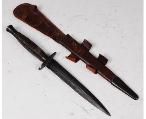 A Fairbairn Sykes 3rd pattern commando fighting knife, the 16.5cm double edged blade By Wilkinson Sword Co Ltd, having an ova