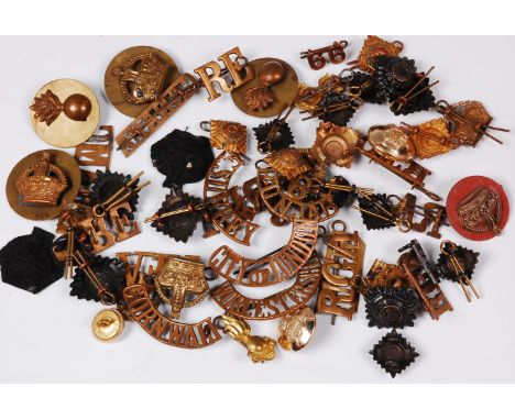 A collection of assorted shoulder titles and insignia to include City of London, Royal Army Medical Corps, Royal Tank Corps a