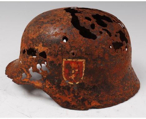A German 1935 model steel helmet with remains of Danzig decal.