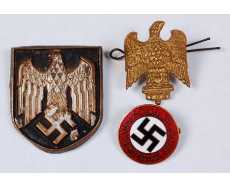 An NSDAP Nazi party enamelled lapel badge, marked verso RZM M1/157, together with an Afrika Corps pith helmet badge and one o