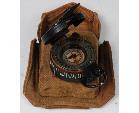A WW II British army Mk III compass, impressed TG. Co. Ltd No.B 30267 and dated 1944, in fitted webbing pouch. Condition Repo