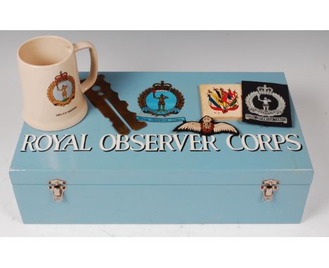 A Royal Obersever Corps painted wooden box, the contents to include R.A.F. cloth badge, various cap badges and tankard etc., 