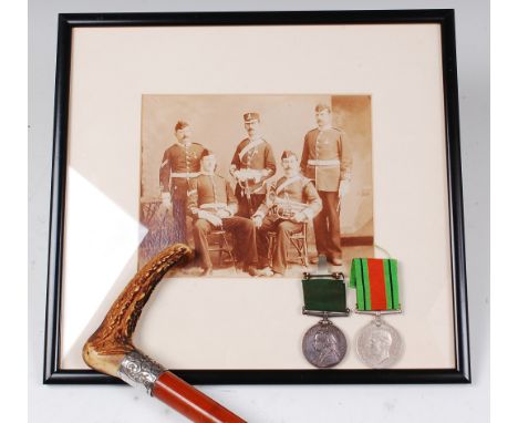 A Victorian Long Service in the Volunteer Force medal, together with a malacca and horn handled walking stick, the silver col