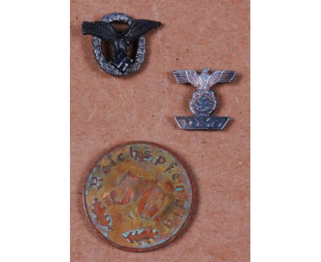 A German Luftwaffe Pilot Observer's stick pin, together with one other and a 1939 50 Riechspfennig coin. (3)