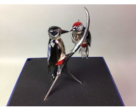 SWAROVSKI CRYSTAL GROUP OF TWO LOVEBIRDS, in original box, modelled perched on silver branch21cm high 22cm tall, item does co