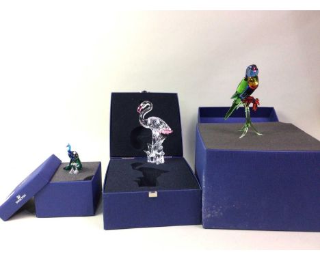 THREE SWAROVSKI CRYSTAL FIGURES, the first modelled as a flamingo, the second a parakeet and the third a peacock, each in ori