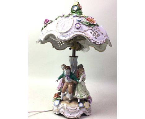 GERMAN CERAMIC TABLE LAMP, AND THREE OTHER LAMPS the German lamp decorated with flowers in relief, the support column modelle