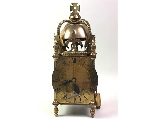 REPRODUCTION BRASS LANTERN CLOCK, with crown decorated bell, circular dial with Roman numerals and 30 hour movement30cm high