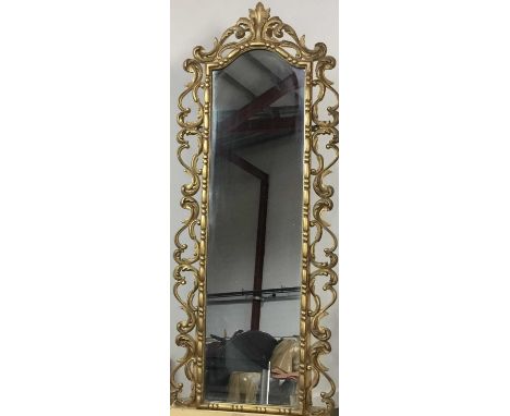 GILT FRAMED WALL MIRROR, ALONG WITH A MAHOGANY FRAMED WALL TAPESTRY the mirror with scrolling designmirror 128cm high