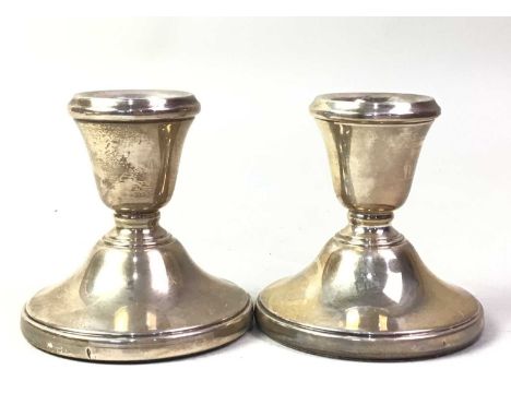 PAIR OF SILVER NAPKIN RINGS, AND OTHER SILVER ITEMS  including a mug, two spoons, a pair of filled candlesticksQty: 160g (not