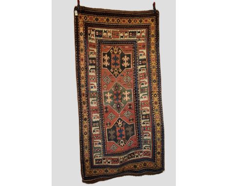 Kazak three medallion rug, south west Caucasus, early 20th century, 8ft. 5in. X 4ft. 5in. 2.56m. X 1.35m. Slight wear in plac