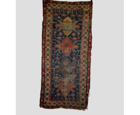 Karabakh long rug woven with a camel train at the top end, south west Caucasus, early 20th century, 8ft. 2in. X 3ft. 10in. 2.