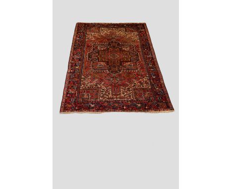 Heriz carpet, north west Persia, circa 1920s-30s 12ft. 4in. X 8ft. 10in. 3.76m. X 2.69m. 'bite' and small damage to top right