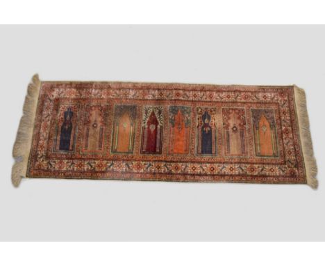 Kayserie 'art' silk saf, north central Anatolia, circa 1940s-50s,  7ft. 2in. X 2ft. 10in. 2.18m. X 0.86m. Eight prayer niches