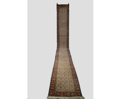 Narrow Kashmiri silk runner, north India, last quarter 20th century,  24ft. 1in. X 2ft. 6in. 7.35m. X 0.76m. Minute surface m