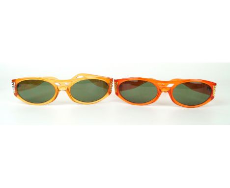 Versus by Gianni Versace: Two pairs of vintage sunglasses
Both in a transparent orange, with gold tone detail, each bearing t